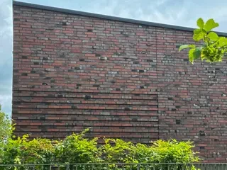 bunte Klinkerfassade mit rustikal deformierten Verblendklinkern und lebendigem Farbspiel